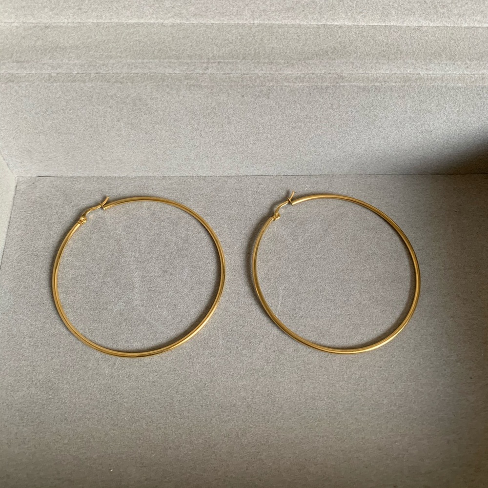 Gold toned large hoop earrings. NWOT.